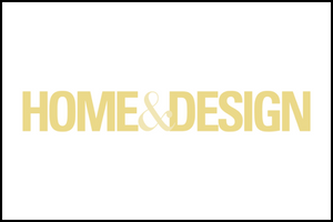 Yellow text on a white background reads HOME & DESIGN in all capital letters, with the word AND represented by a large ampersand symbol. A thin black border frames the image.