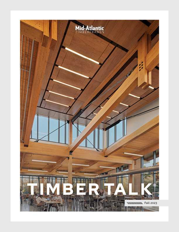 Magazine cover featuring modern interior with large wooden beams, high ceiling, and tall windows. The title TIMBER TALK and Mid-Atlantic Timberframes are displayed, with Fall 2023 noted in the corner.