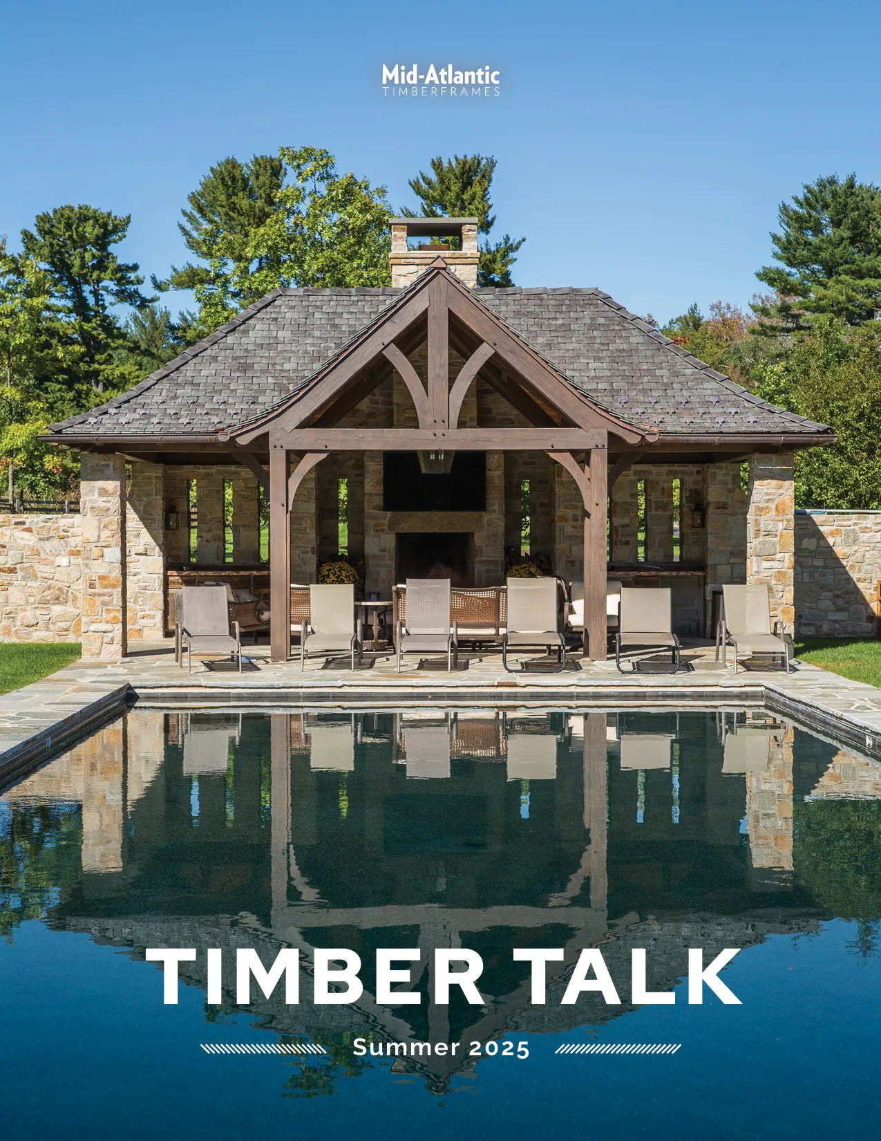 A wooden poolside pavilion with lounge chairs sits beside a rectangular pool, reflecting the structure. Surrounded by trees and stone walls, the image appears on the cover of Timber Talk Summer 2025 edition.